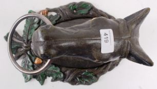 A cast iron wall mountable dog stay in the form of a horse.