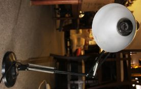 A vintage 20th century black anglepoise industrial desk lamp having heavy circular base with