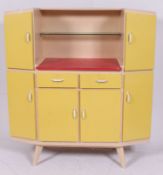 A 1950's retro yellow and white two tone kitchen cabinet dresser with multiple drawers and shelves.