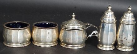A collection of silver hallmarked condiments to include 2 salts with blue glass liners,