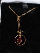 A 9ct gold and ruby garnet stone ladies necklace and pendant set.