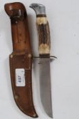 A vintage French made Sabatier knife with horn handle and decorative plaques within the original