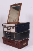 A stack of vintage suitcases to include leather example,
