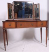 A Regency style mahogany ladies dressing table raised on tapered supports having a series of
