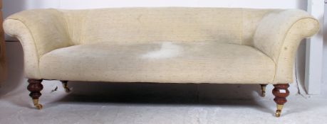 A Victorian mahogany large Chesterfield sofa settee raised on turned legs with brass castors having