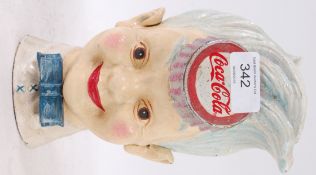A novelty cast iron Coca Cola ' Sprite ' money box, in the form of a boy,