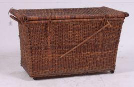 An unusual vintage 20th century whicker carry / travel basket cot having lined interior with cot