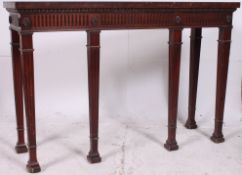 A Regency Irish style mahogany  console table having reeded tapered legs with spade feet having
