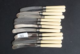 A set of twelve bone handled and silver collared fruit / butter knives.