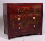 A decorative vintage chinese chest having red chinoserie style finish with central bank of drawers.