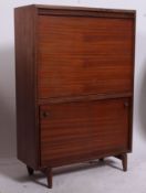 A vintage / retro drinks cabinet having a fully appointed interior accessed by a drop down front