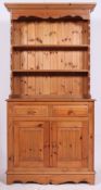 A 20th century pine welsh dresser having cupboards and drawers to the base with upright plate rack