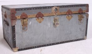A vintage metal steamer trunk of usual form