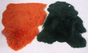 A pair of retro dyed green and orange sheepskin rugs H105 W90cm