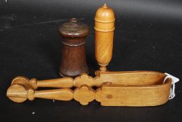 A collection of treen wares to include sugar tongs,