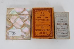 A vintage mother of pearl card holder having hindged lid along with to boxes of ivory visiting