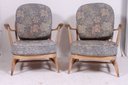 A pair of 1970's retro Ercol beech and elm Windsor pattern armchairs.