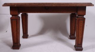 A fabulous Victorian solid oak library table raised on oversized tapered supports with thick table