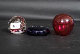 A Selkirk 1996 ' Firedance ' paperweight along with a Cranberry glass and blue glass Bristol