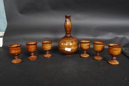 A 20th century studio pottery set comprising decanter,