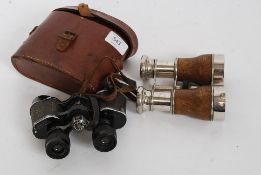A pair of binoculars being marked for Army and NAvy along with a leather cased pair