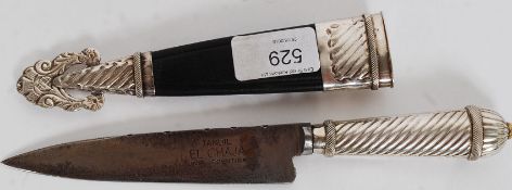 A decorative Islamic style white metal dagger with stunning detailed scabbard cast in relief.