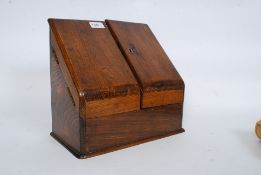 A Victorian oak desk top stationary tidy having twin doors with appointed interior set within