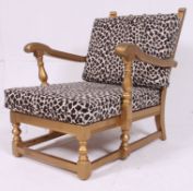 A Shabby Chic Ercol painted gold and leopard skin upholstered armchair.