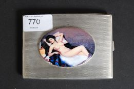 A hallmarked silver cigarette case, with applied ceramic enamel pictorial image of a nude lady.