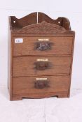 A vintage desk / table top chest of drawers having ivorine labels for Ties, Gloves, Kerchiefs,
