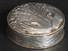 A silver ( tested ) snuff box of circular form having fabulous flowers and hand design in repousse