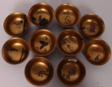 A collection of Chinese wooden laquered rice bowls stylised individually with butterflies, goldfish,