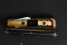 A cased bone and silver inlay cheroot / cigarette holder with original case