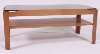 A vintage 1970's retro teak and smoked glass rectangular coffee table being raised on chamfered