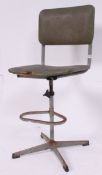 A vintage 1940's metal Industrial machinists chair with the original upholstered green rexxine seat