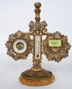 An early 20th century British United Clock Co clock compendium having gilt metal rococo style stand