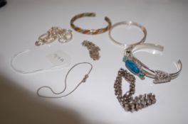 A collection of ladies silver and white bracelets and bangles to include celtic knot, loop, chain,