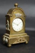 A brass trench art cased pocket watch holder in the form of a bracket clock.