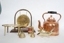 A collection of brass and copper wares to include a gong, hammered kettle,