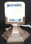 An Edwardian silver hallmarked desktop calander stand complete with the cards.