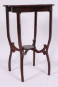An Edwardian mahogany inlaid clover leaf side table raised on squared supports with lower tier