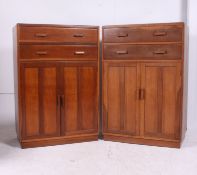 A near pair of utility oak tallboys, two drawers over two door cupboard c.