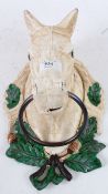 A cast iron wall mountable dog stay in the form of a horse.