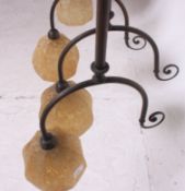 A pair of vintage Art Deco style brass ceiling lights having tubular stems with pendant shades