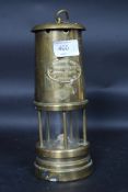 A vintage brass miners lamp bearing plaque for Ferndale Coal and Mining Company