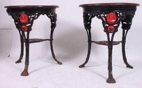 A pair of old cast iron circular pub tavern tables / table having relief cast portrait busts of