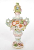 A 19th century Meissen continental glazed twin handled amphora miniature vase adorned with flowers