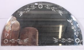 A large frameless arched Venetian style bevelled edge wall mirror.