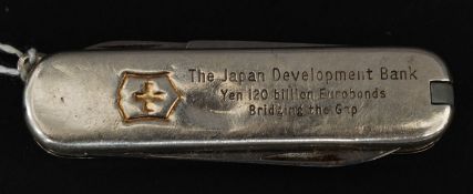 A Tiffany & Co silver and 18ct gold pen knife being marked to the side.