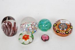 A good collection of 6x glass paperweights, including a good caned glass example, Murano,